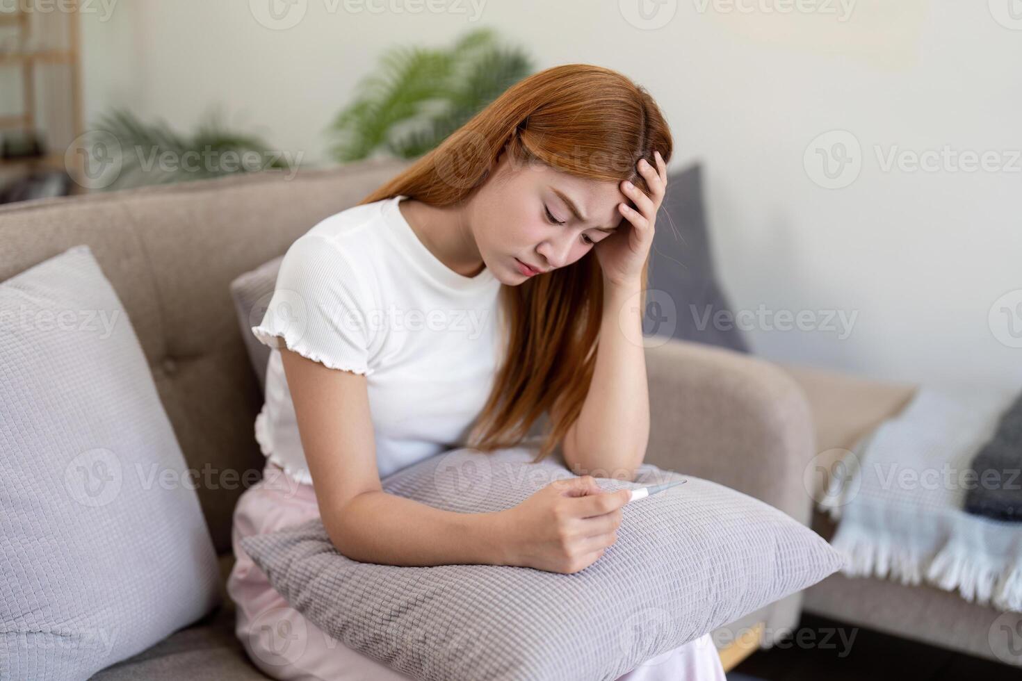 Woman Concerned About Fever While Resting. Home Illness Management photo