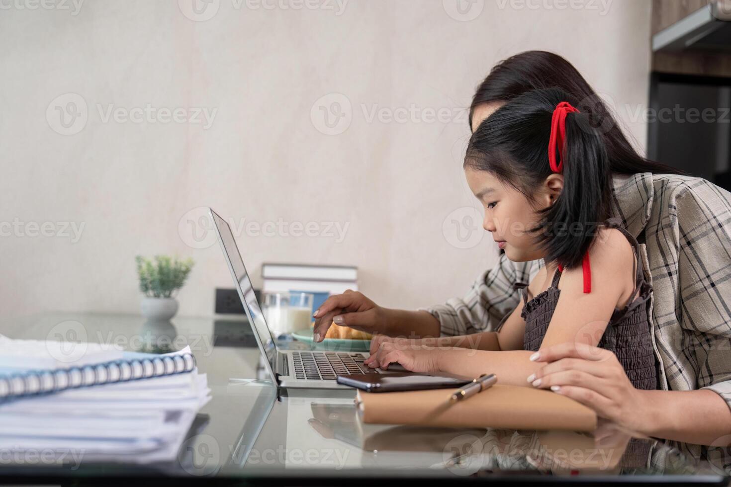 Mother and Daughter Engaged in Remote Work Environment . Family and Career Balance photo