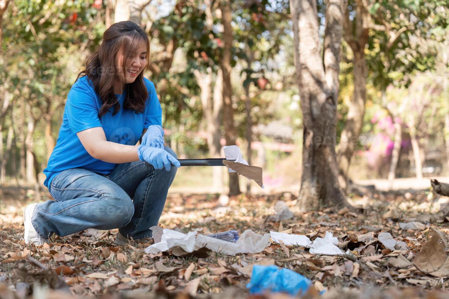 Volunteer Using Litter Picker in Woodland Clean Up photo