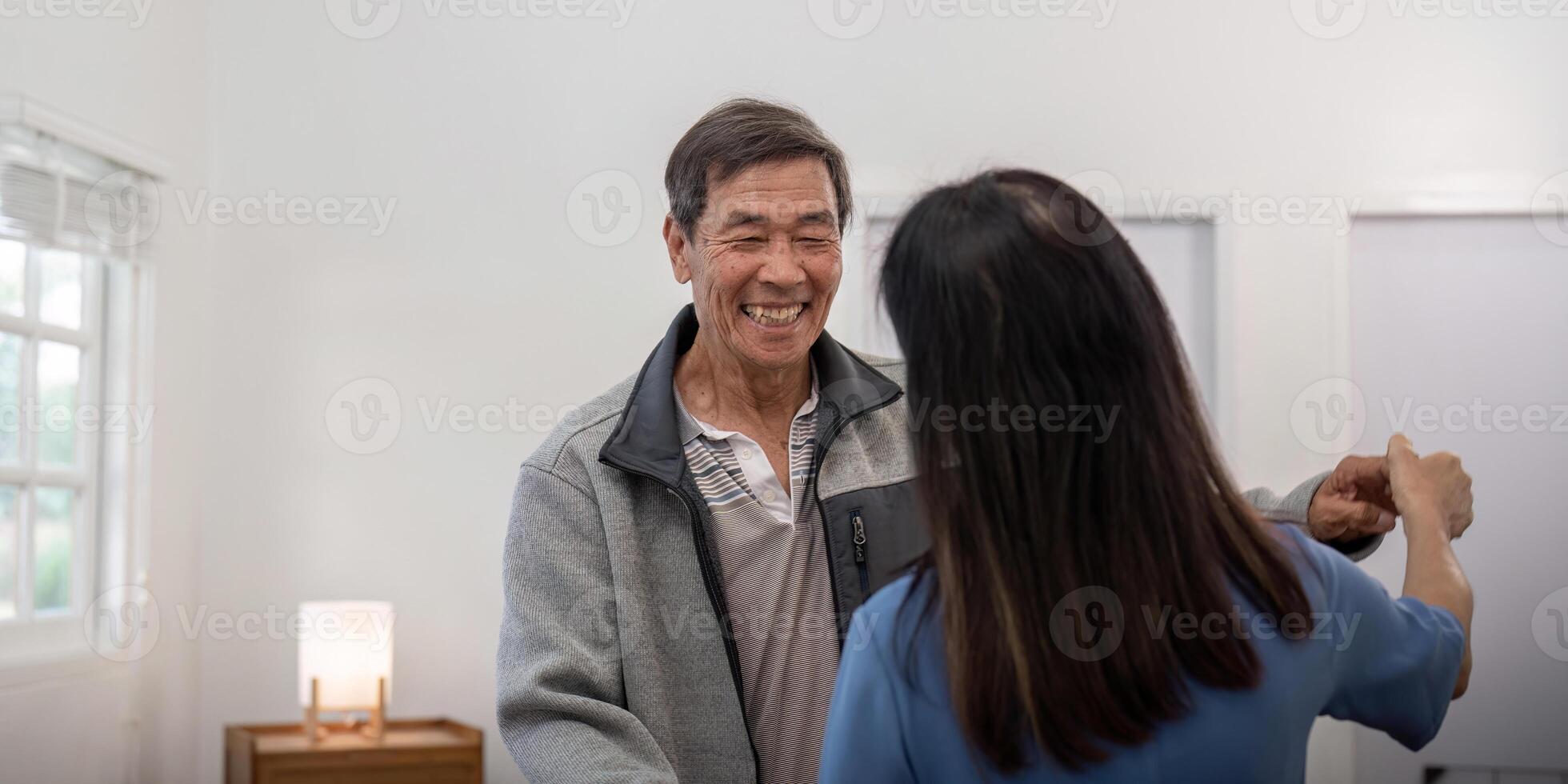Senior couple holding hands and dancing cheerfully photo