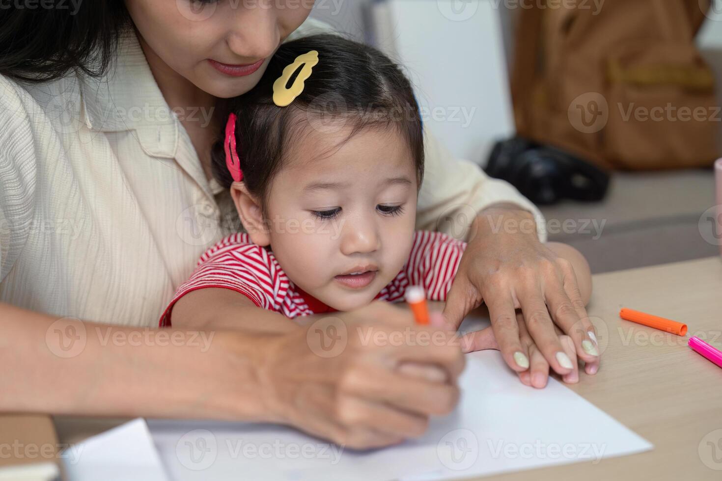 Mother and daughter drawing together at home photo
