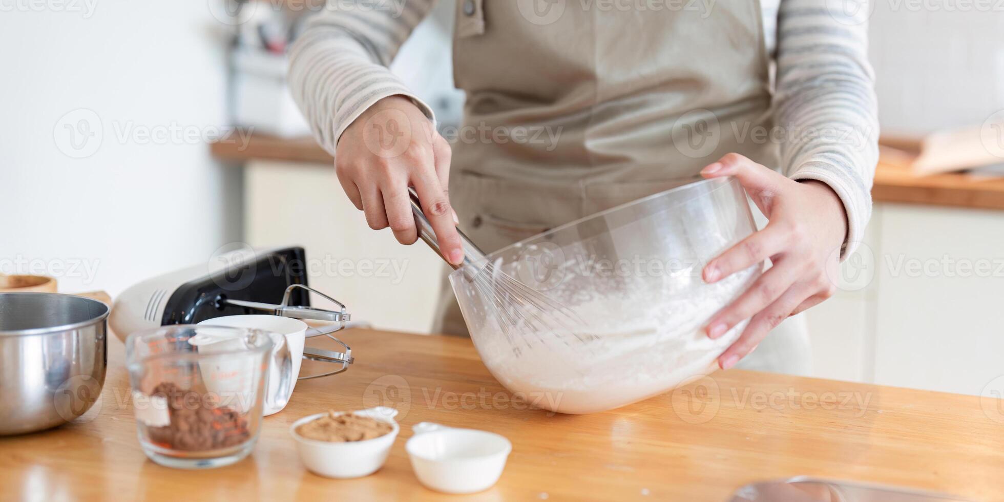Close-up of mixing cake batter in modern kitchen setting photo