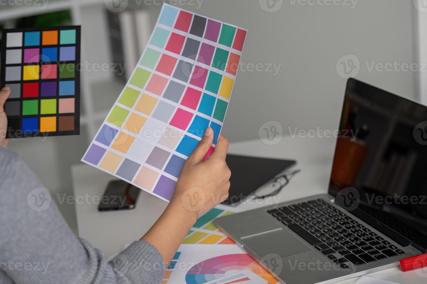 Graphic designer reviewing color palette for creative project photo