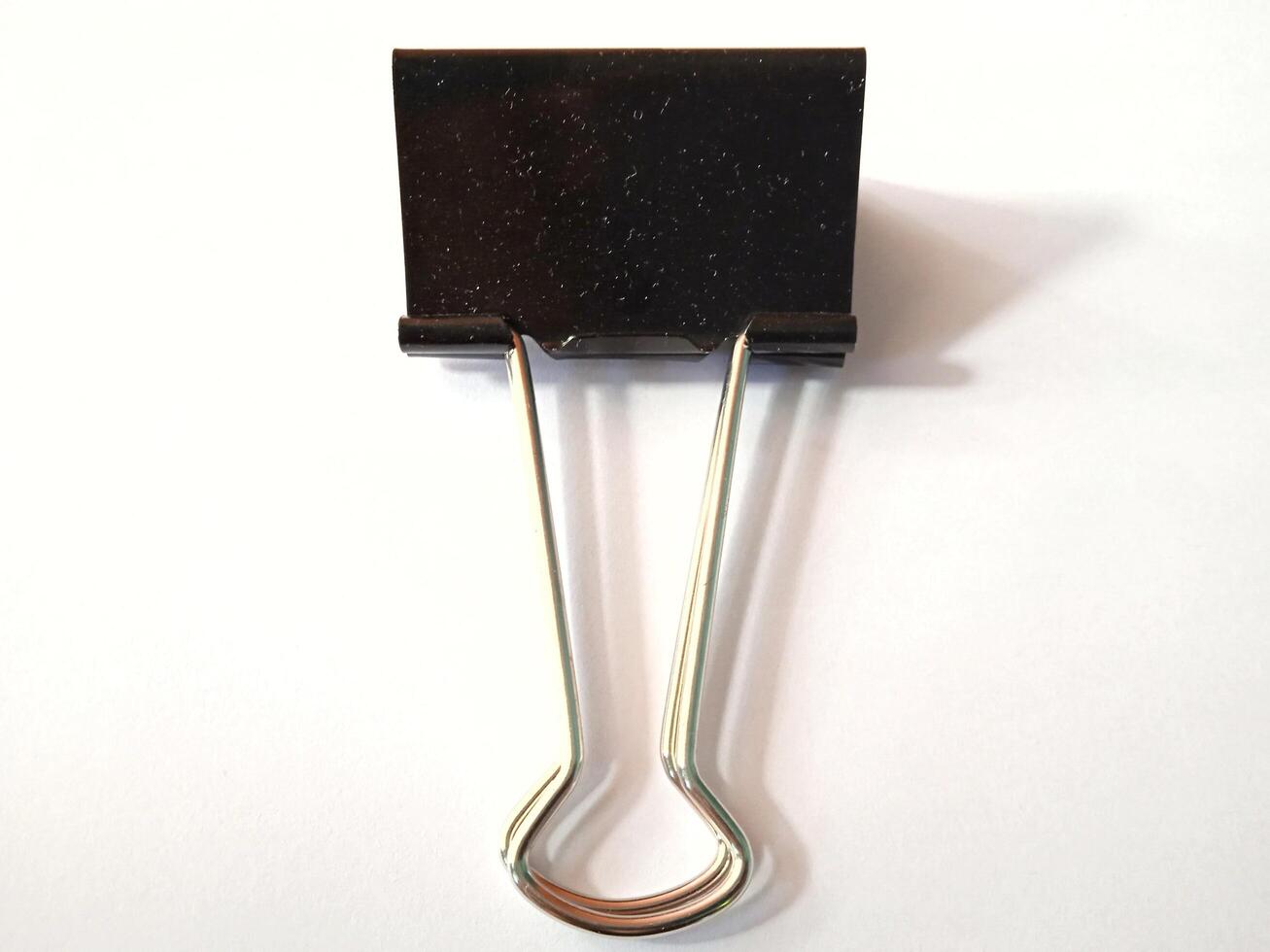 Black paperclip on a white background photo