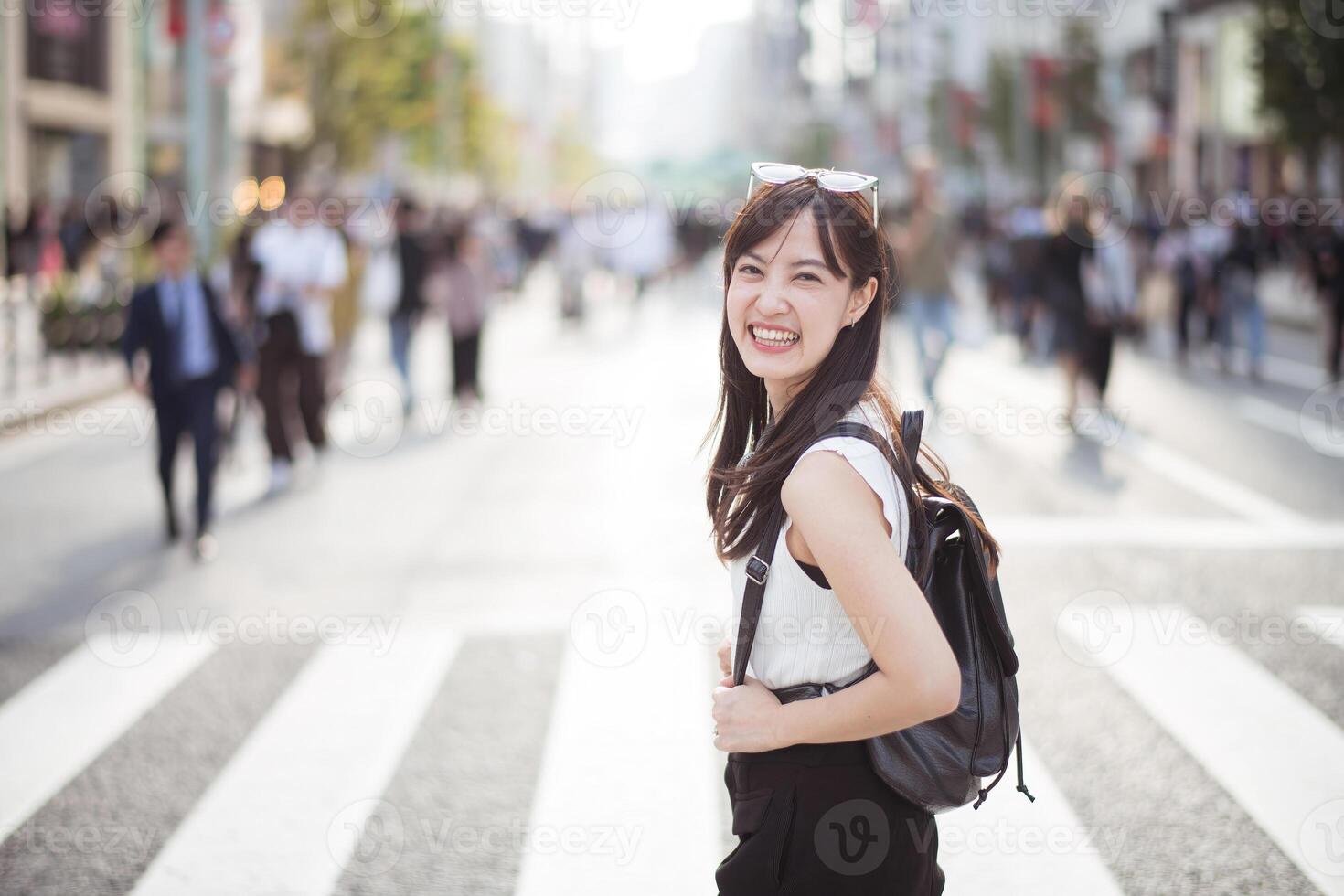 Tokyo's pulse, Unidentified Asian individuals crossing paths, embodying the vibrant energy of the city. photo
