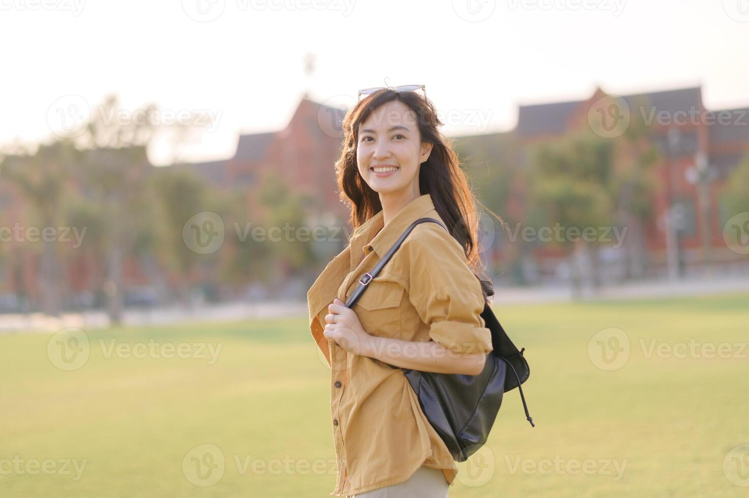 Traveler asian woman in her 30s stands bathed in the golden glow of sunset, embracing the freedom of exploration. on summer holiday weekend vacation trip in Bangkok, Thailand photo
