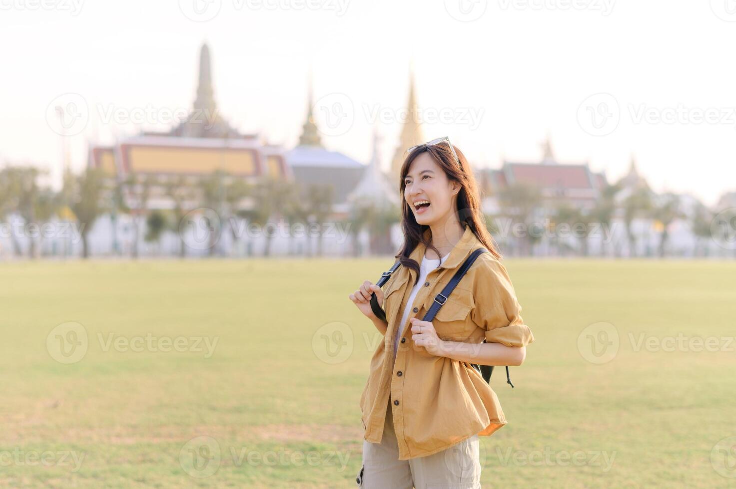 A Traveler Asian woman in her 30s exploring Wat Pra Kaew. From stunning architecture to friendly locals, she cherishes every moment, capturing it all in her heart and camera for years to come. photo
