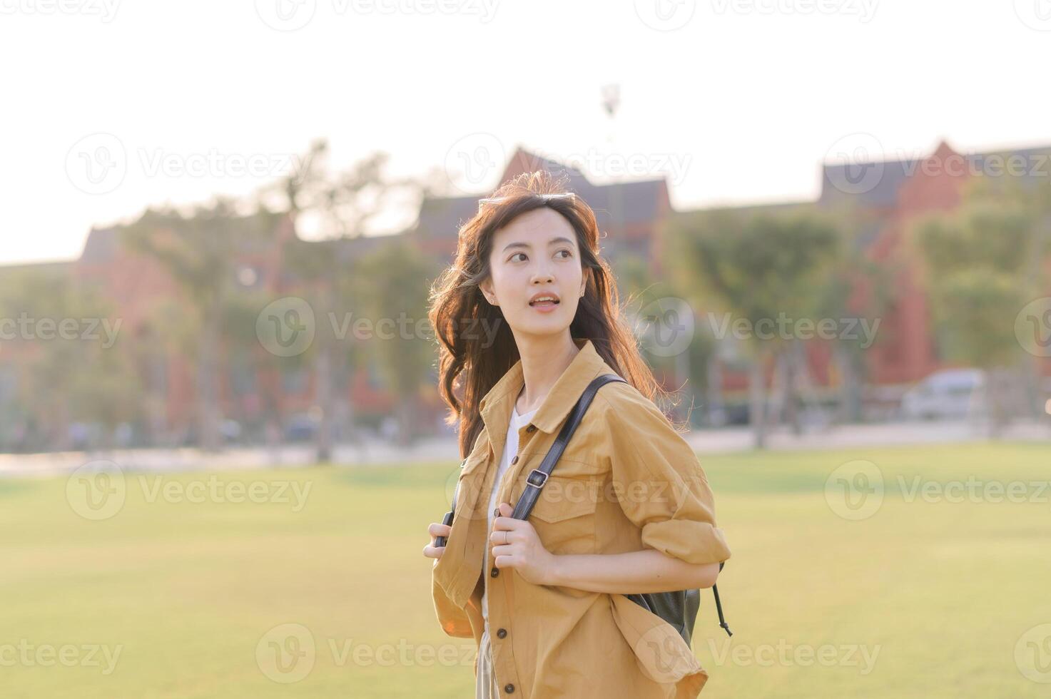 Traveler asian woman in her 30s stands bathed in the golden glow of sunset, embracing the freedom of exploration. on summer holiday weekend vacation trip in Bangkok, Thailand photo