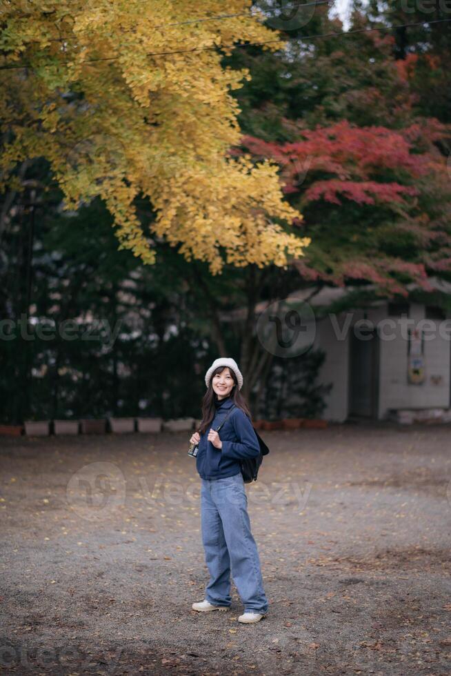 Asian woman, dressed casually, explores Japanese shrines and temples in Tokyo and Kyoto. A blend of nature, tradition, and relaxation on a holiday retreat. photo