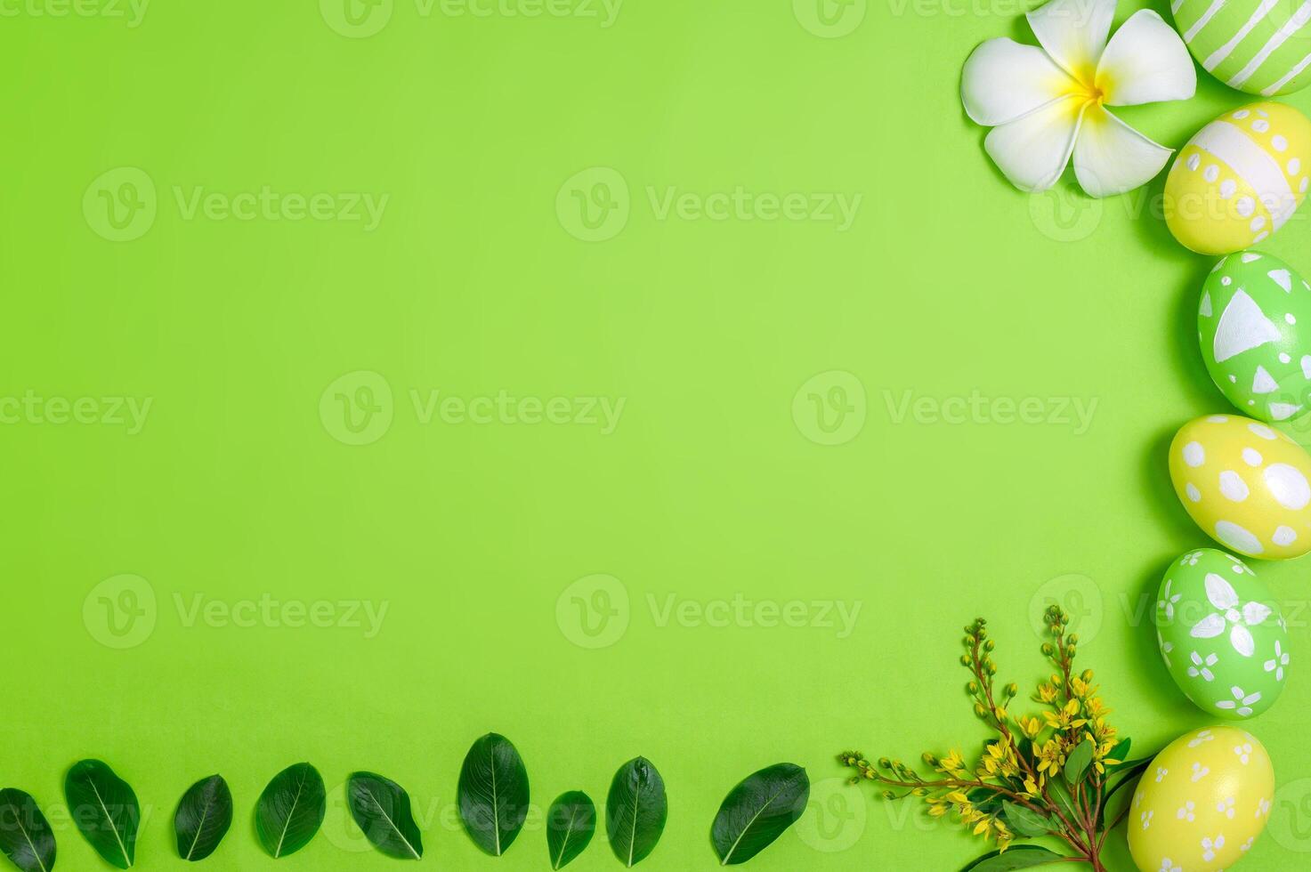 Happy Easter holiday greeting card design concept. Colorful Easter Eggs and spring flowers on pastel green background. Flat lay, top view, copy space. photo