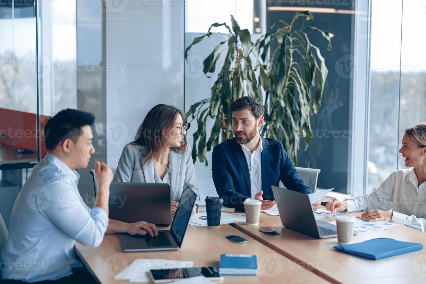 Creative business team working on project in modern office with panoramic view photo
