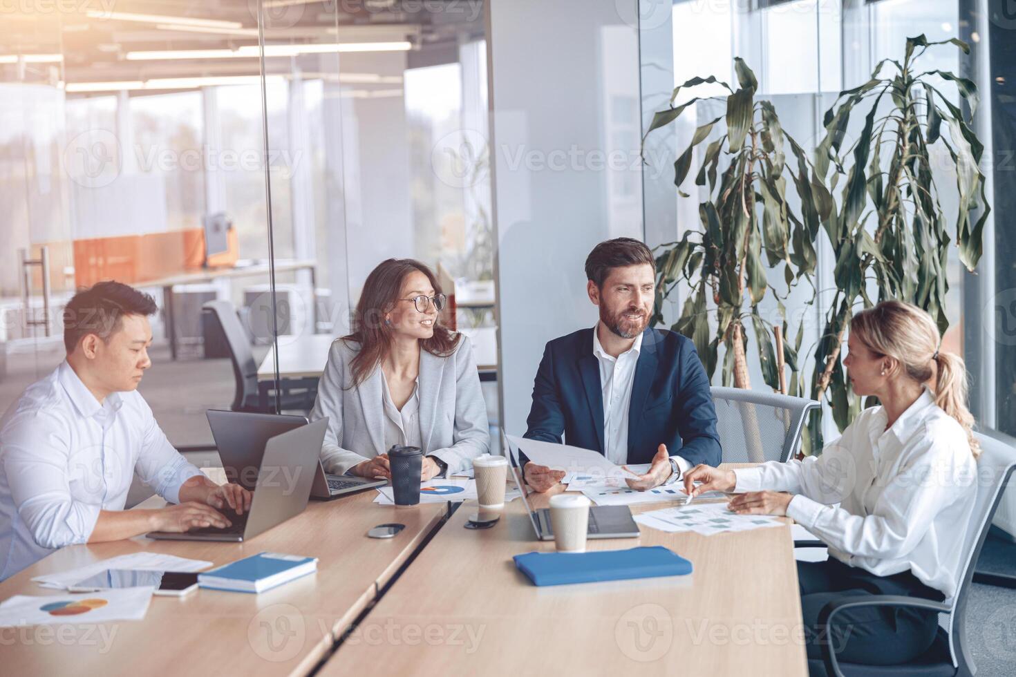 Corporate business team and manager in a meeting room at modern office with panoramic windows photo