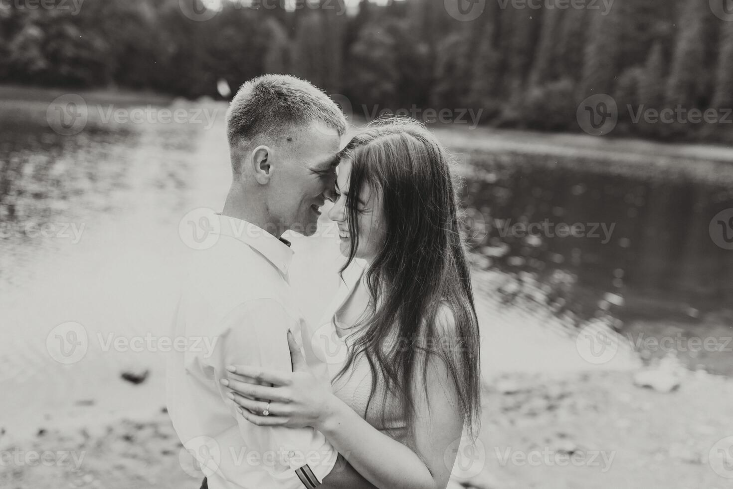 A couple is hugging in the rain, with the man's shirt wet photo
