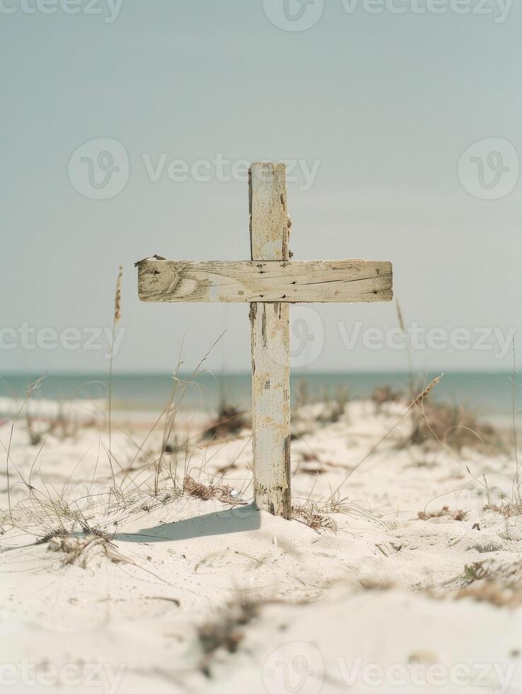 A wooden cross on the beach with blue sea and sky background photo