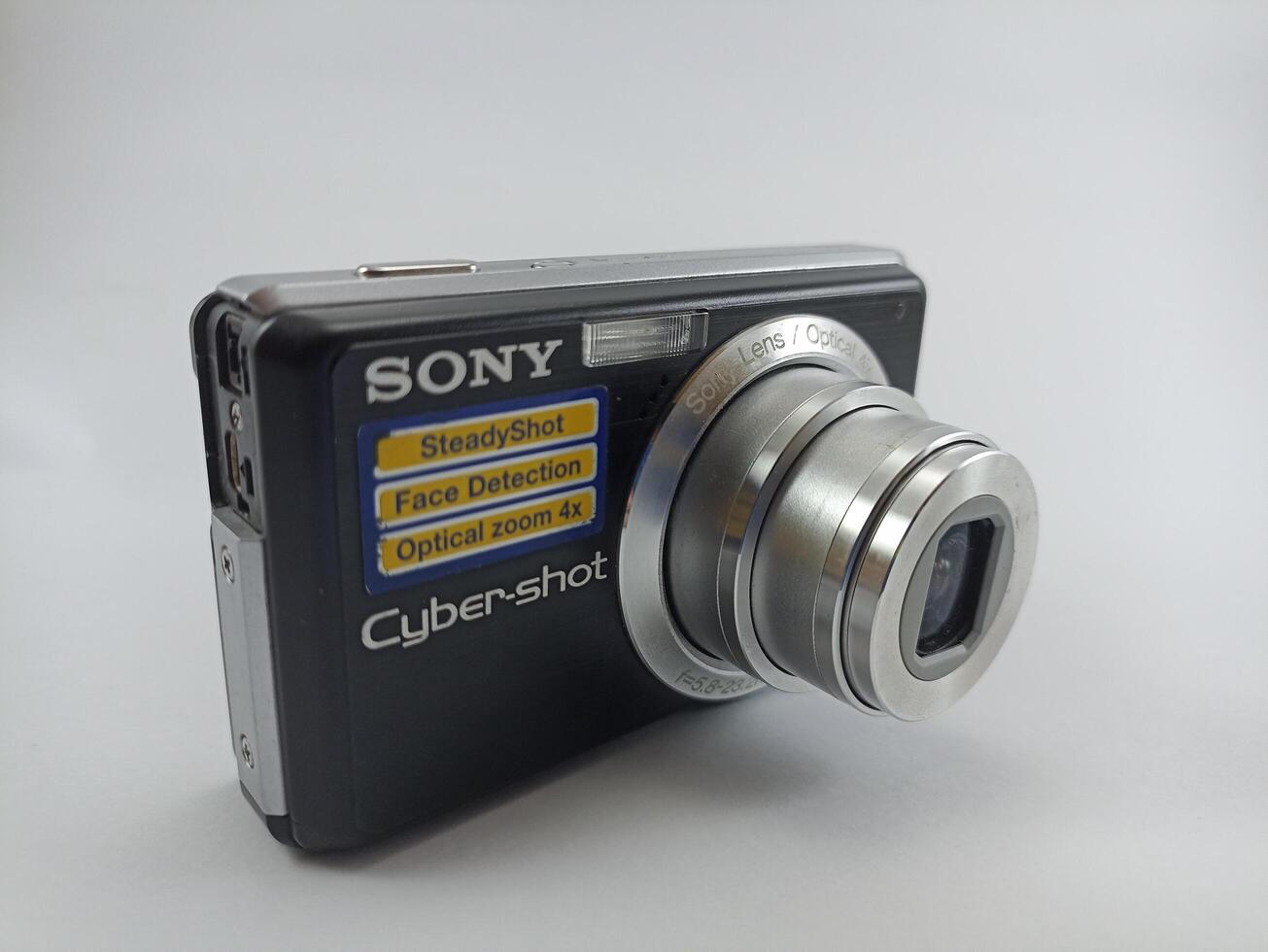 Wonosobo, Central Java, Indonesia August 7 2024 front view of an old Sony digital pocket camera isolated on a white background, Sony Cybershot, photography equipment photo