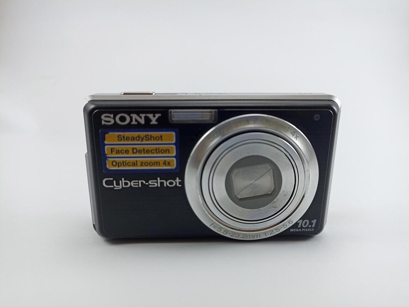 Wonosobo, Central Java, Indonesia August 7 2024 front view of an old Sony digital pocket camera isolated on a white background, Sony Cybershot, photography equipment photo
