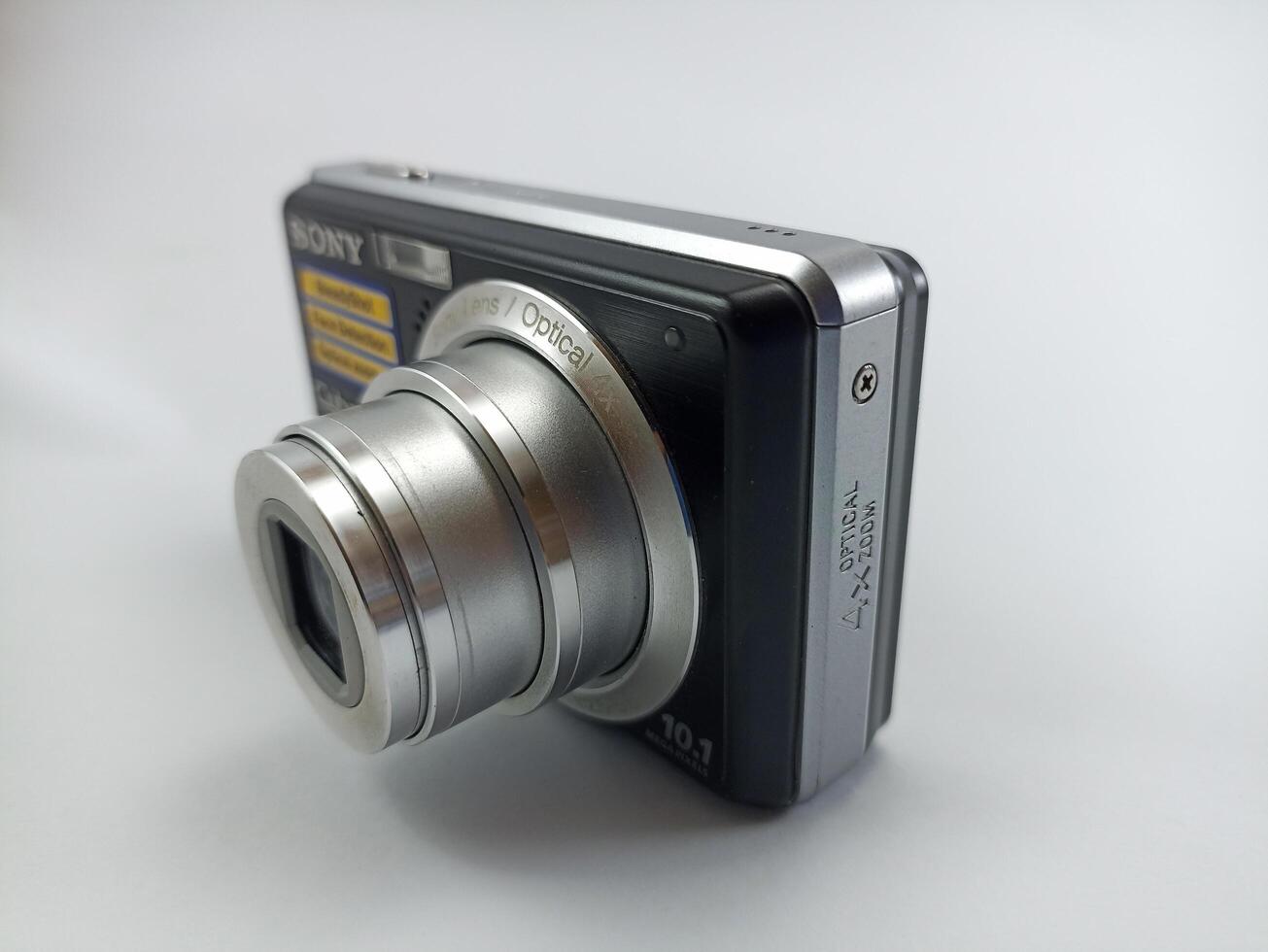 Wonosobo, Central Java, Indonesia August 7 2024 front view of an old Sony digital pocket camera isolated on a white background, Sony Cybershot, photography equipment photo
