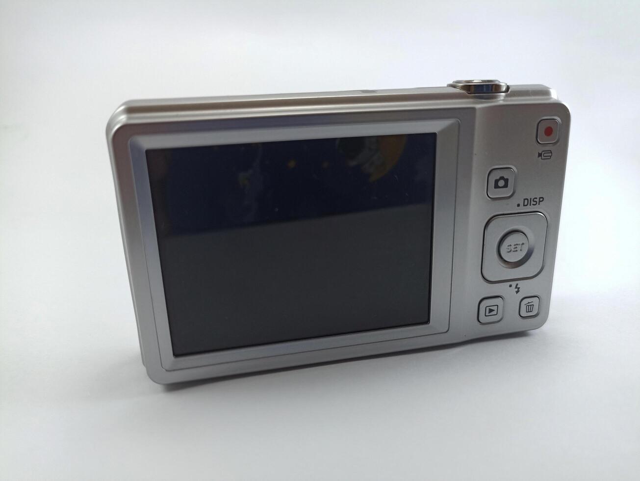 rear view of old digital pocket camera isolated on white background, photography equipment photo