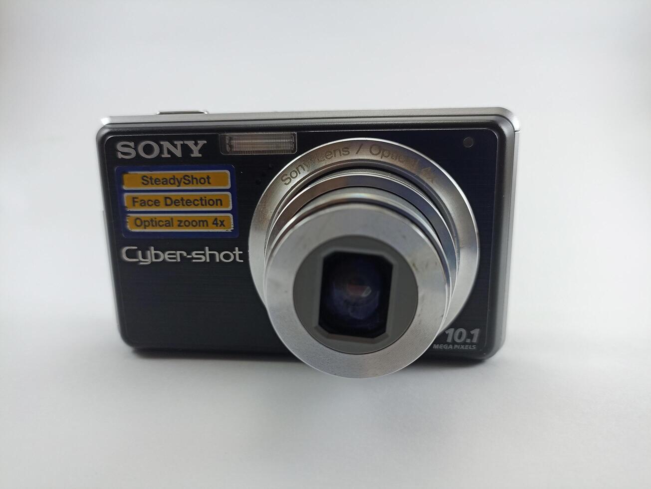 Wonosobo, Central Java, Indonesia August 7 2024 front view of an old Sony digital pocket camera isolated on a white background, Sony Cybershot, photography equipment photo