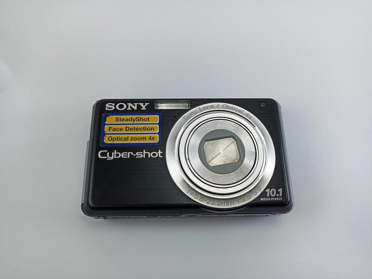 Wonosobo, Central Java, Indonesia August 7 2024 front view of an old Sony digital pocket camera isolated on a white background, Sony Cybershot, photography equipment photo