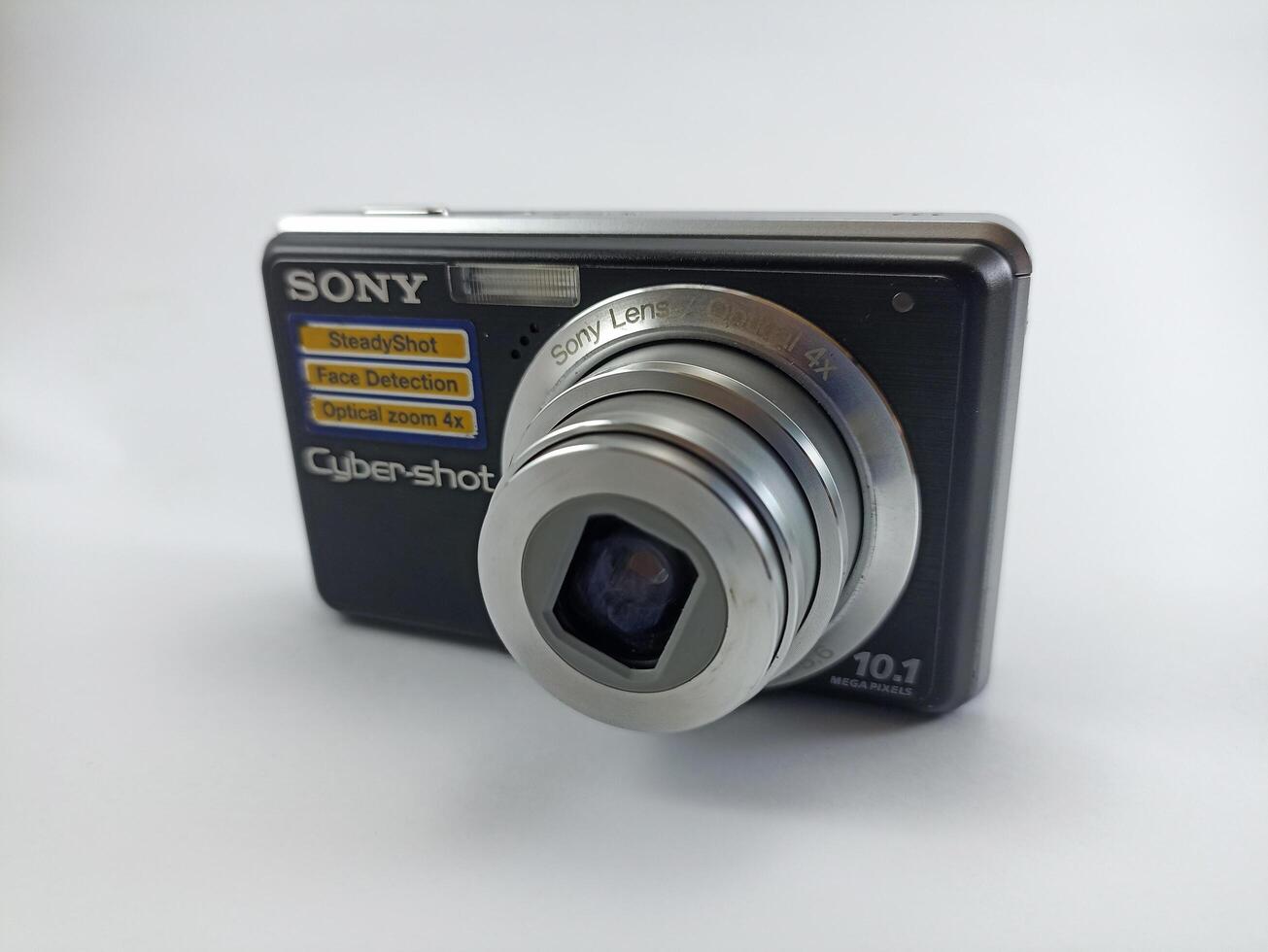 Wonosobo, Central Java, Indonesia August 7 2024 front view of an old Sony digital pocket camera isolated on a white background, Sony Cybershot, photography equipment photo