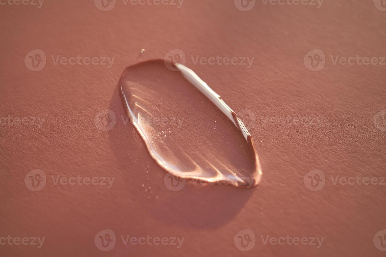 Beautiful volumetric drop of cosmetic product on a pink background. photo