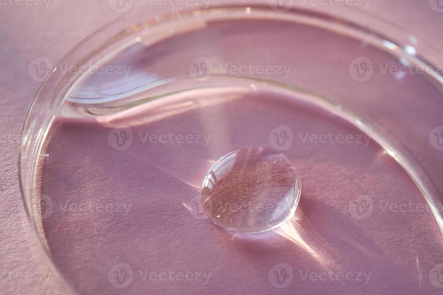 Beautiful volumetric drop of cosmetic product on a pink background. photo