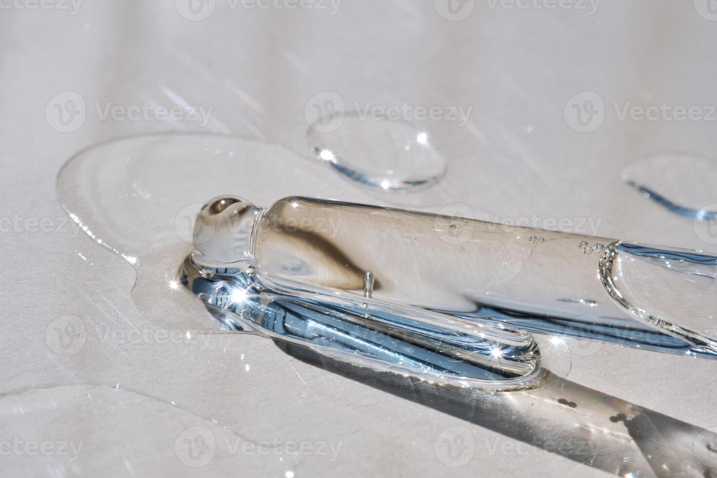 Pipette with serum on a beige background. photo