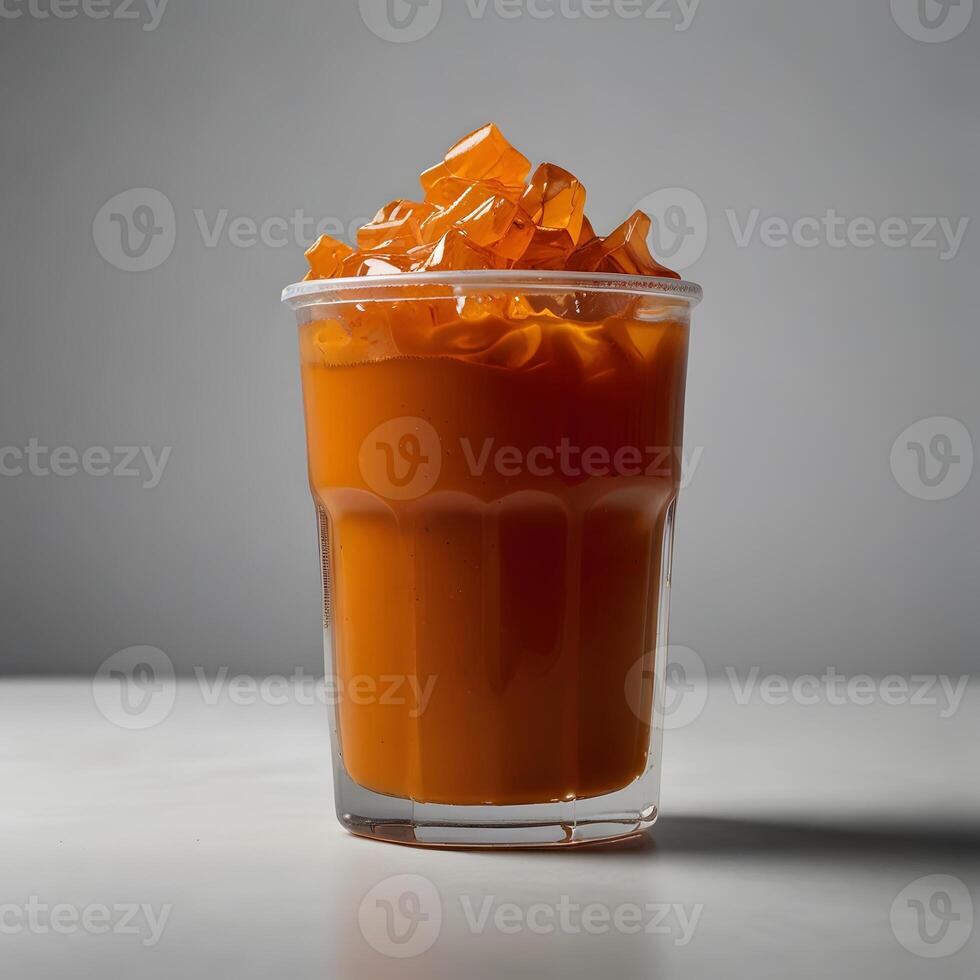 Clear plastic cup filled with thai tea and a lid, isolated white background, studio lighting for focused advertising. photo
