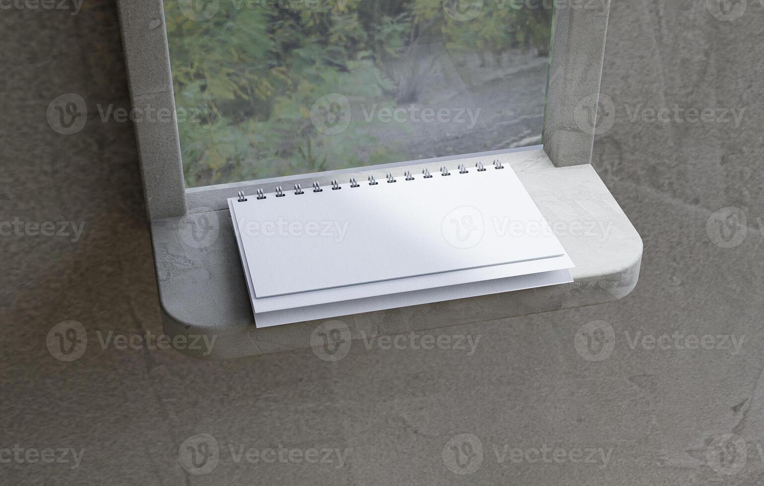 A spiral calendar lying open on a ledge photo