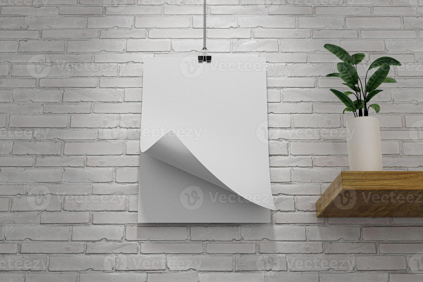 A white poster hanging on a brick wall with one corner flipped over photo