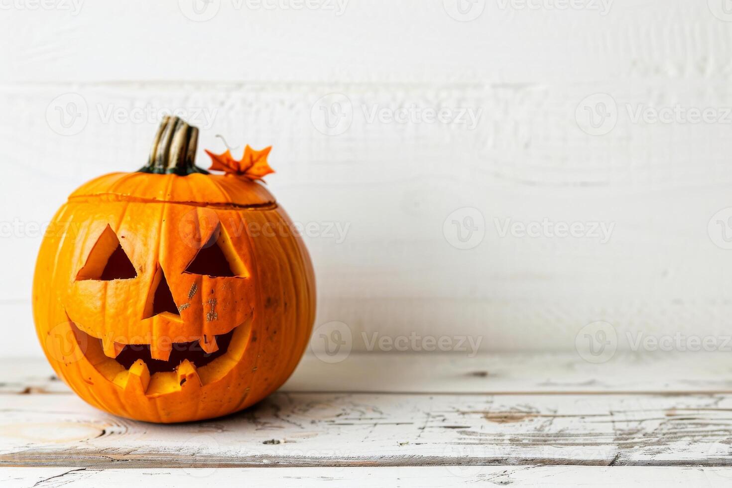 Carved Halloween pumpkin on rustic white background photo