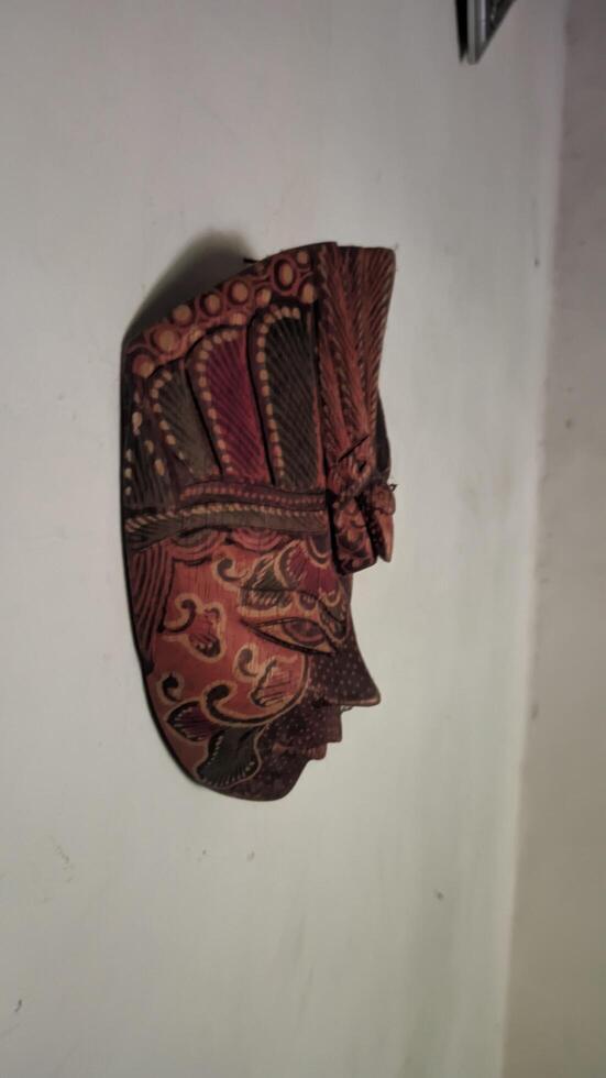 a decorative mask hanging on the wall photo