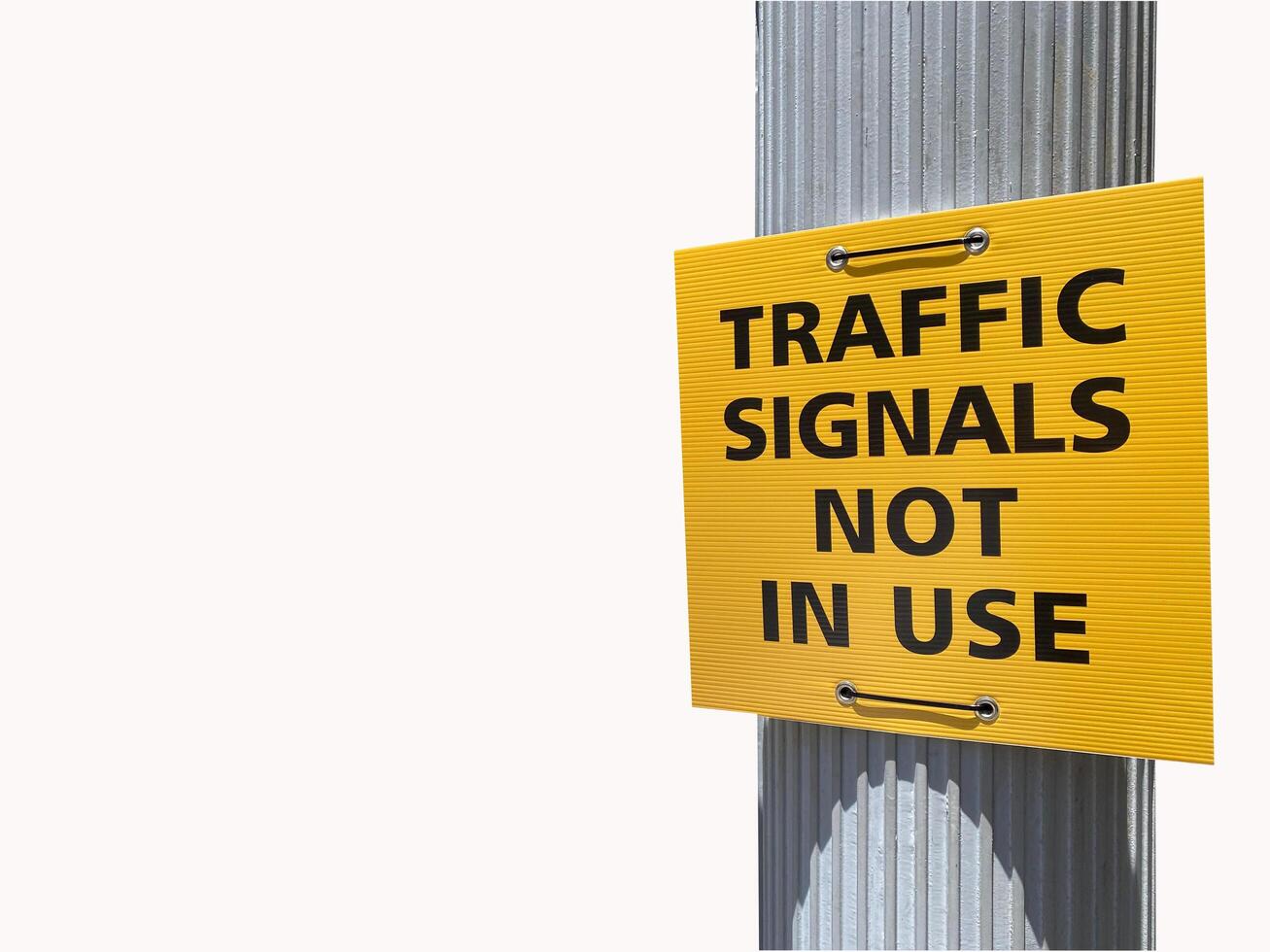 Traffic signal not in use sign in square yellow board on silver pole isolated on white background photo