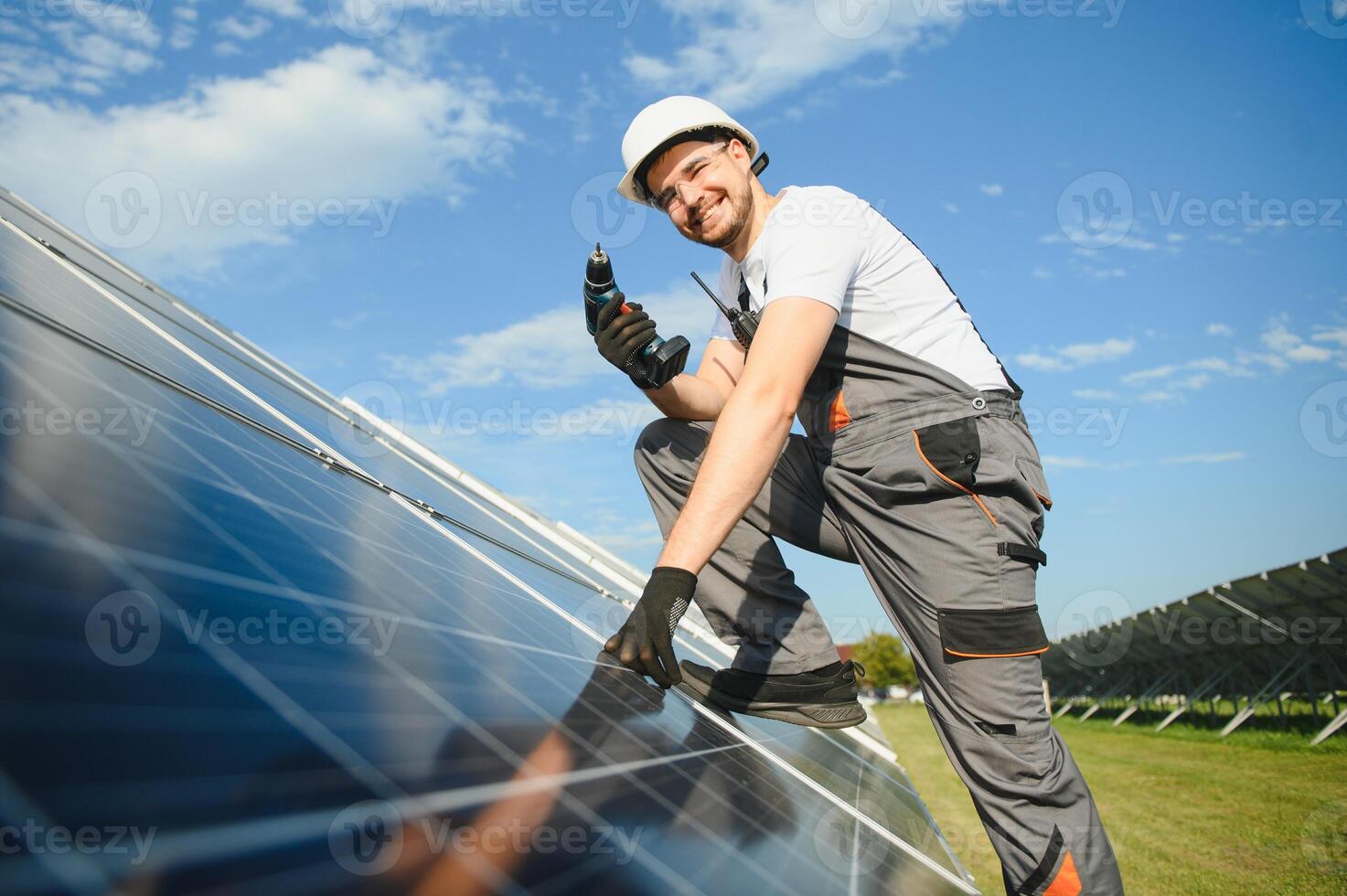 Worker installing solar panels outdoors photo