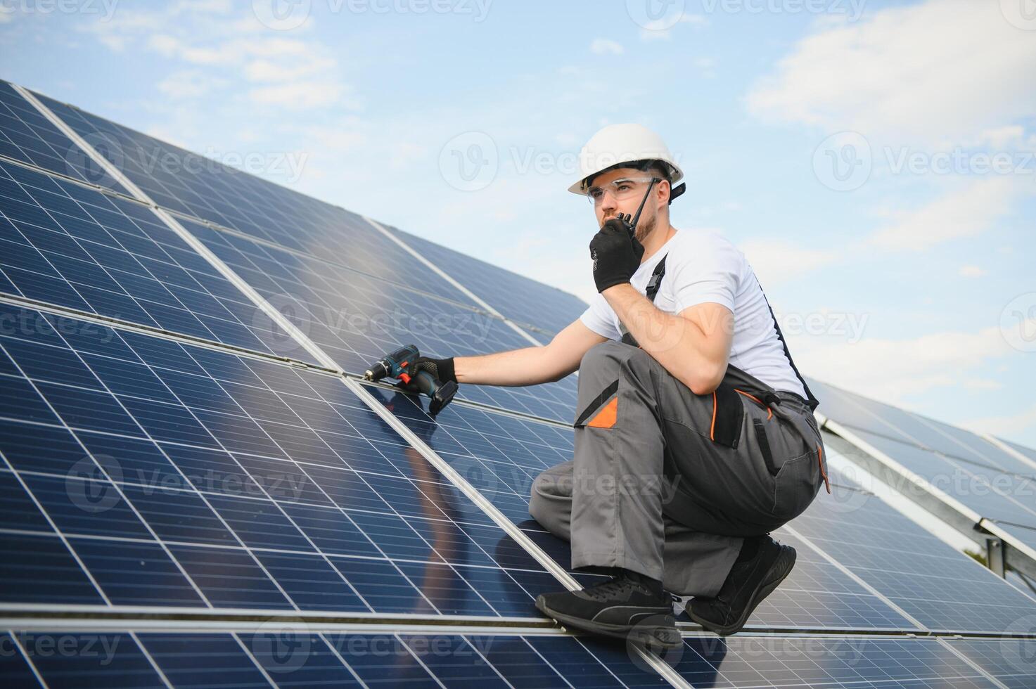 Worker installing solar panels outdoors photo