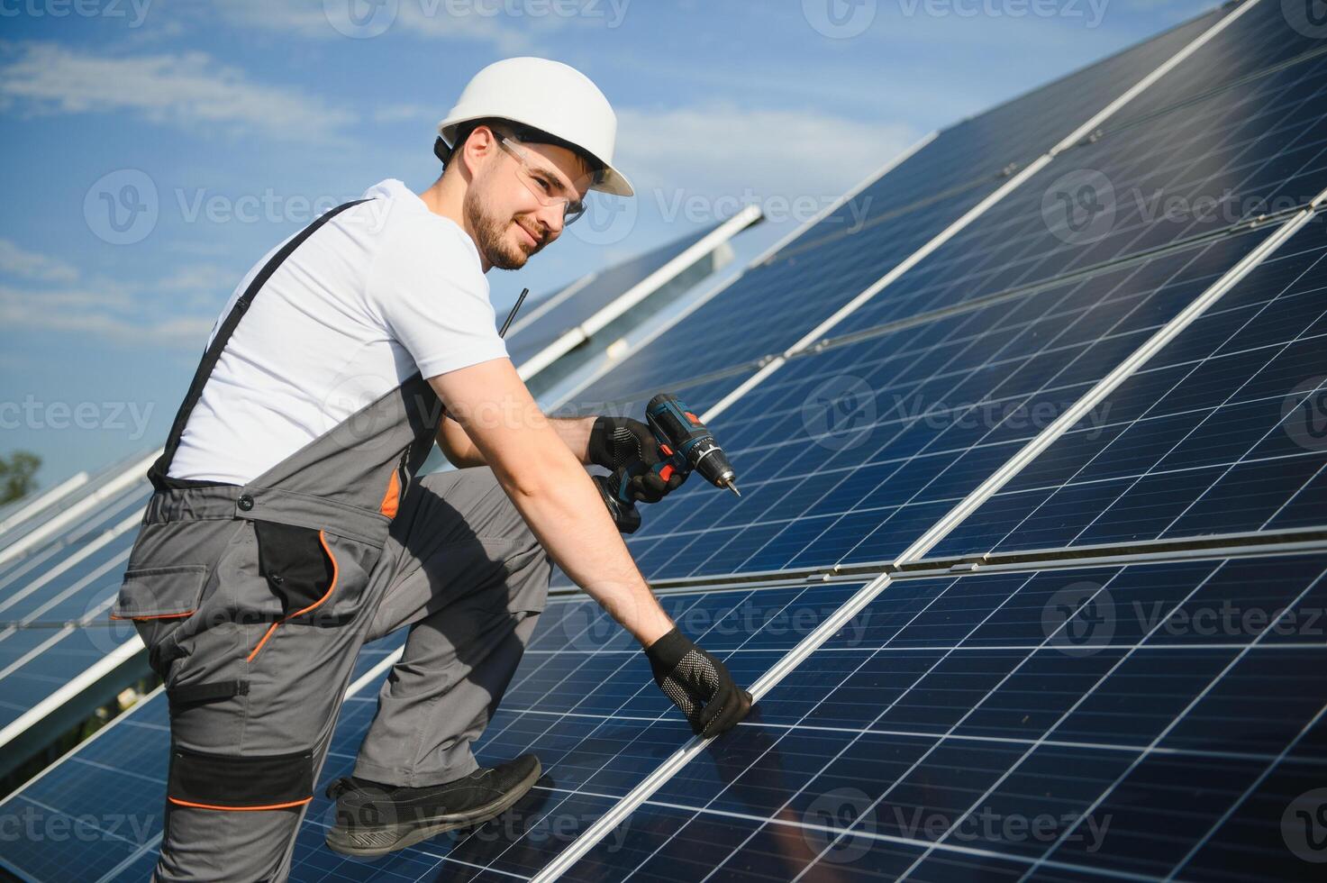 Worker installing solar panels outdoors photo