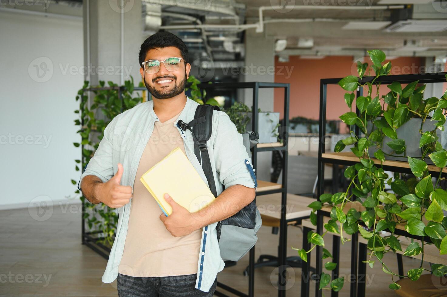 Happy indian male student at the university photo