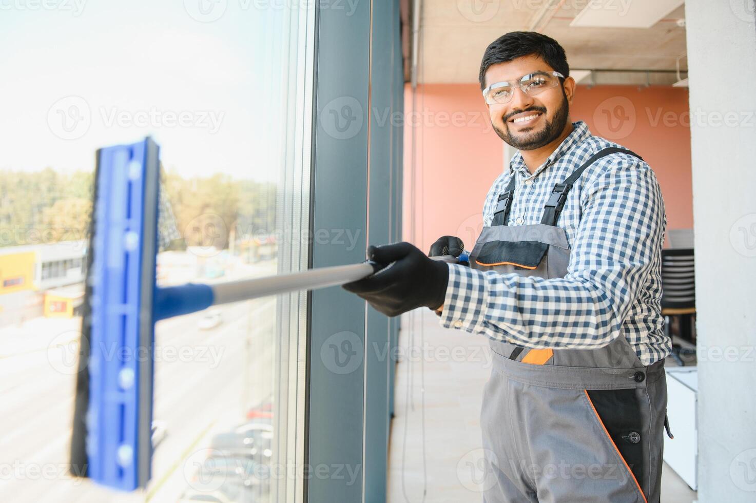 Cheerful male person cleaning window photo