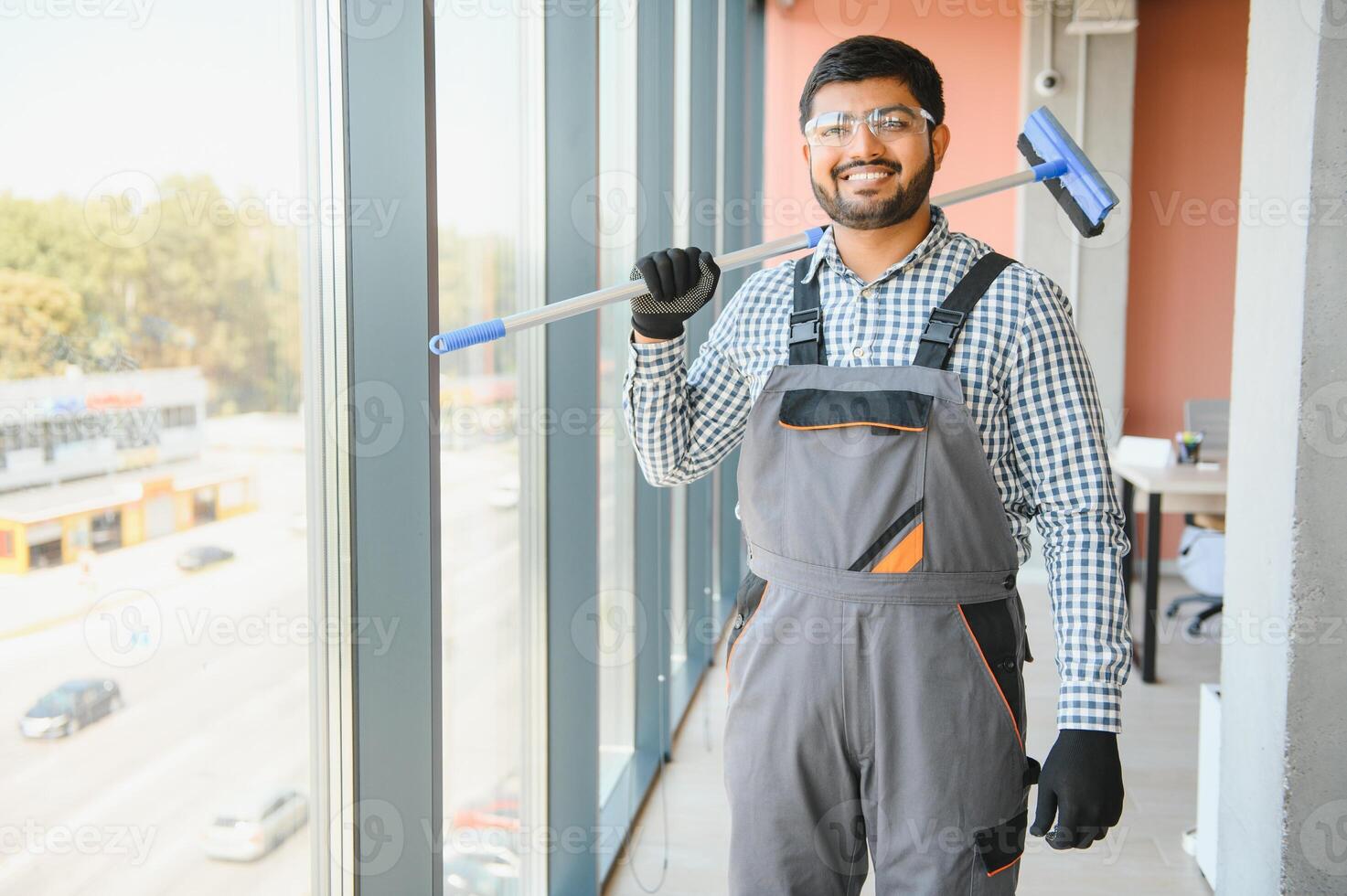 Cheerful male person cleaning window photo