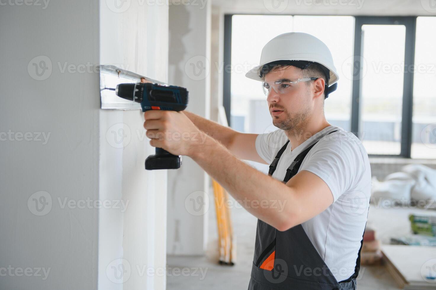 Construction worker installing metal profile for interior partition wall, while building a new house or renovation process photo