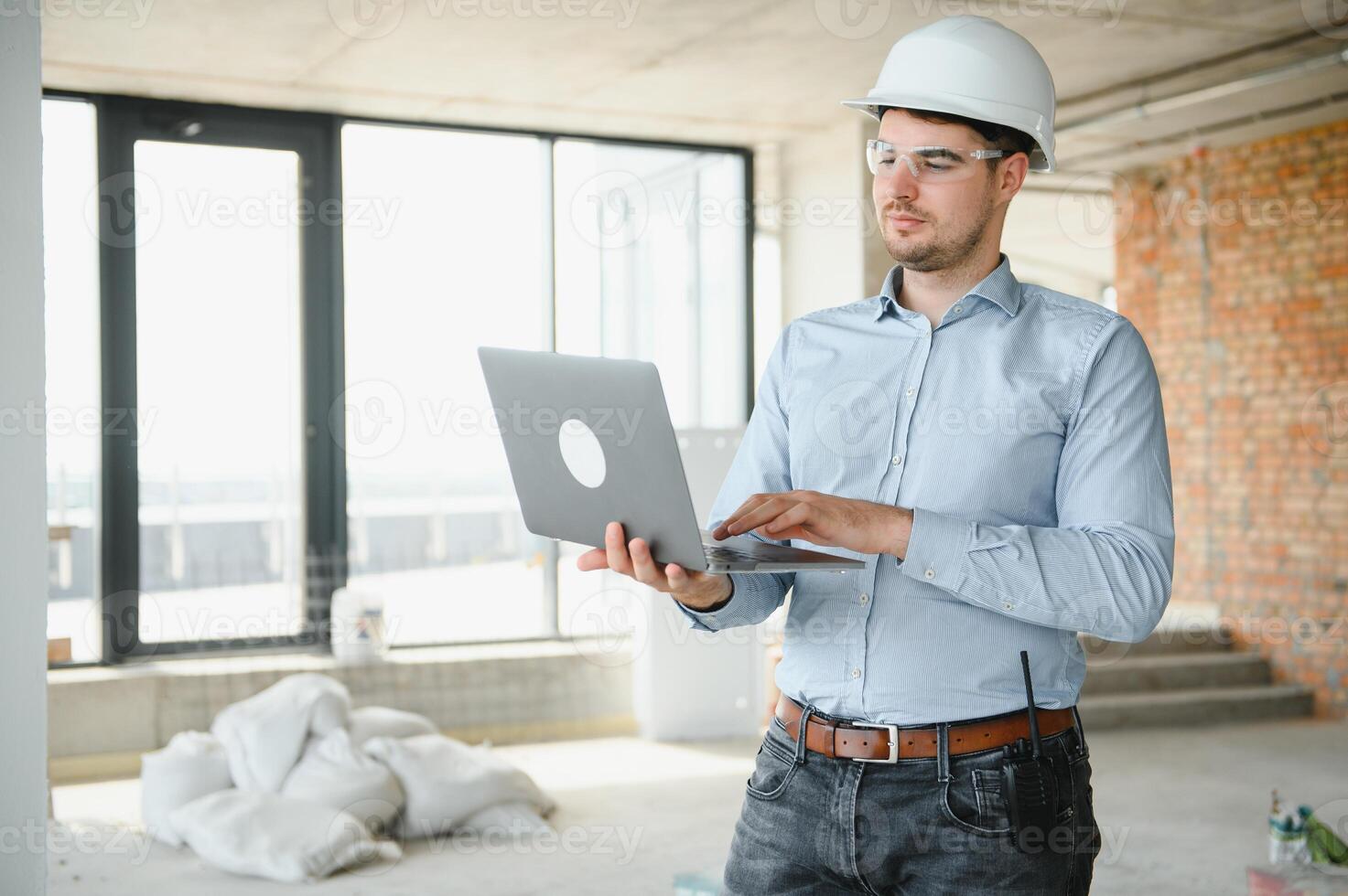 Man builder. Architect at construction site photo