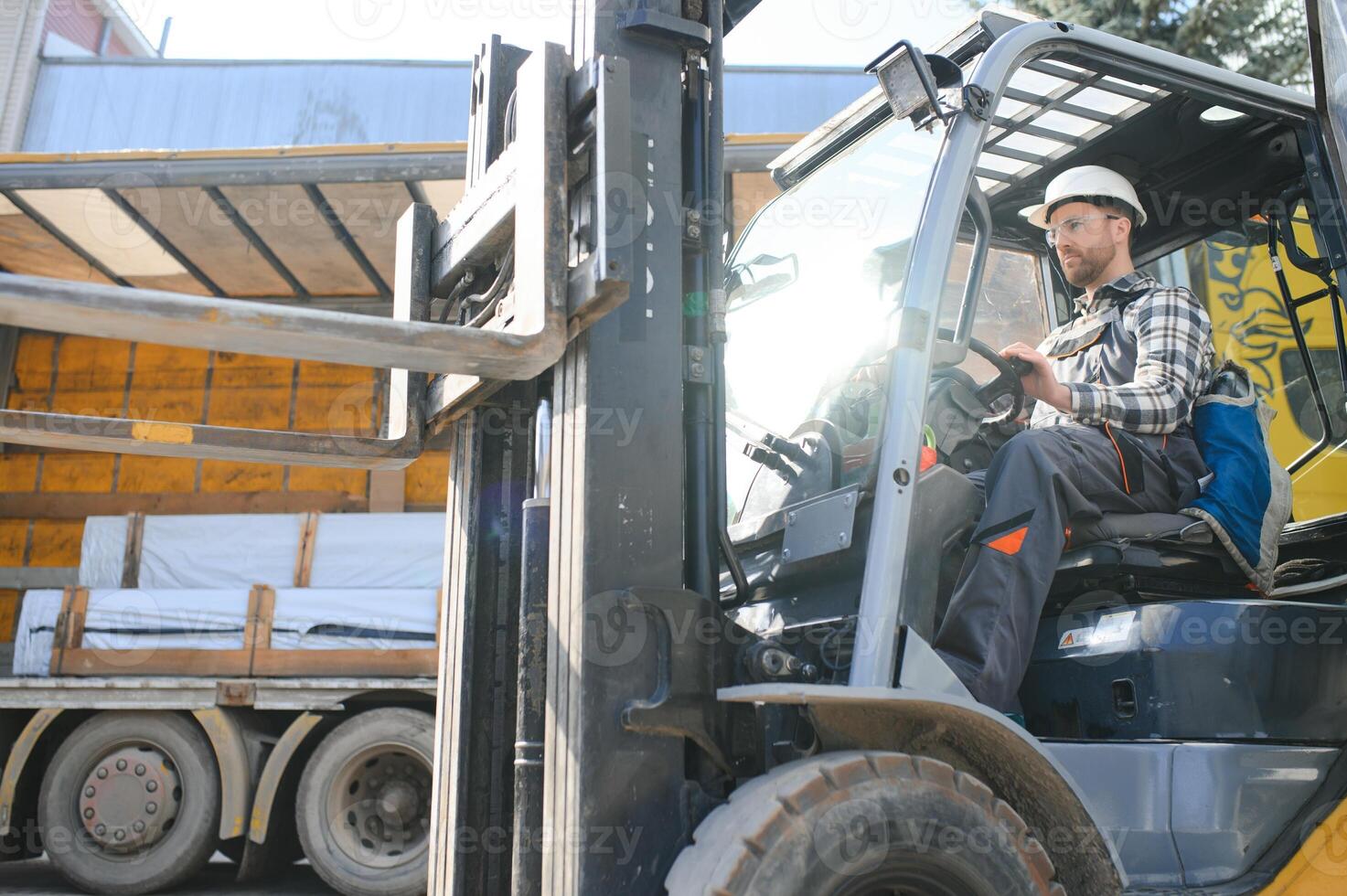 Portrait of heavy industry forklift driver giving thumbs up and smiling photo