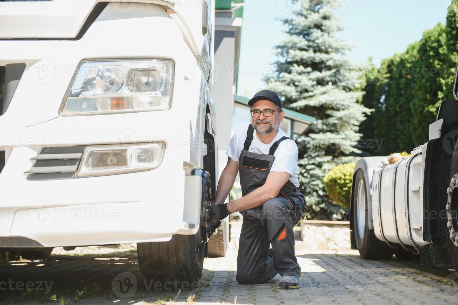 Caucasian Professional Truck Mechanic Rebuilding Heavy Duty Truck Diesel Engine. Automotive Industry Theme photo