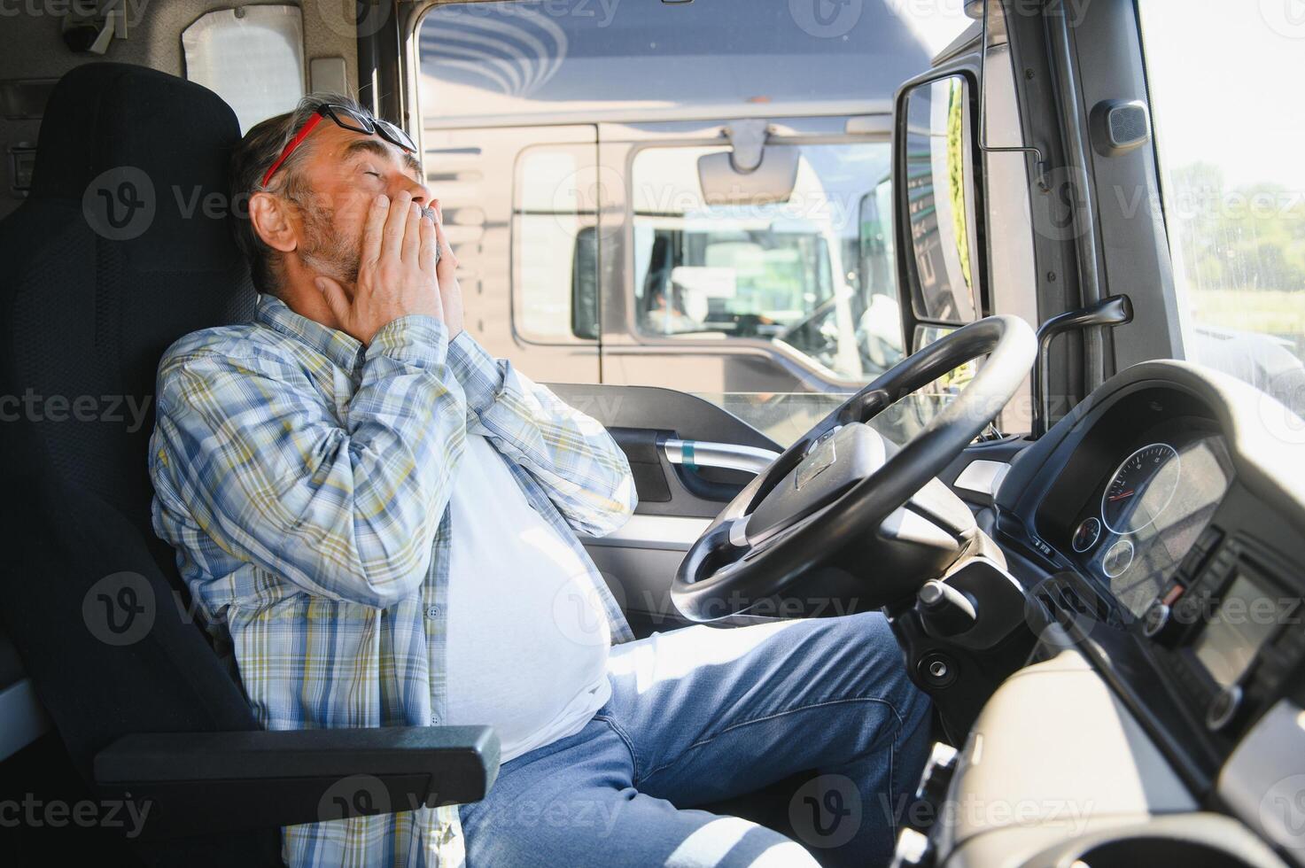 Portrait of tired truck driver feeling sleepy and sick photo