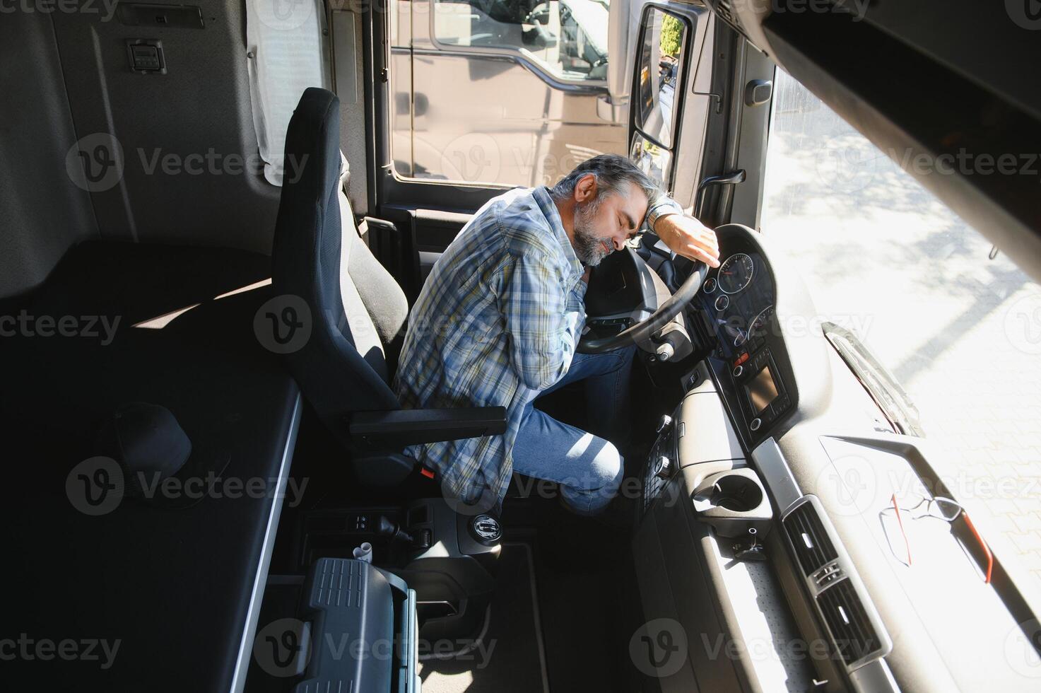 Portrait of tired truck driver feeling sleepy and sick photo