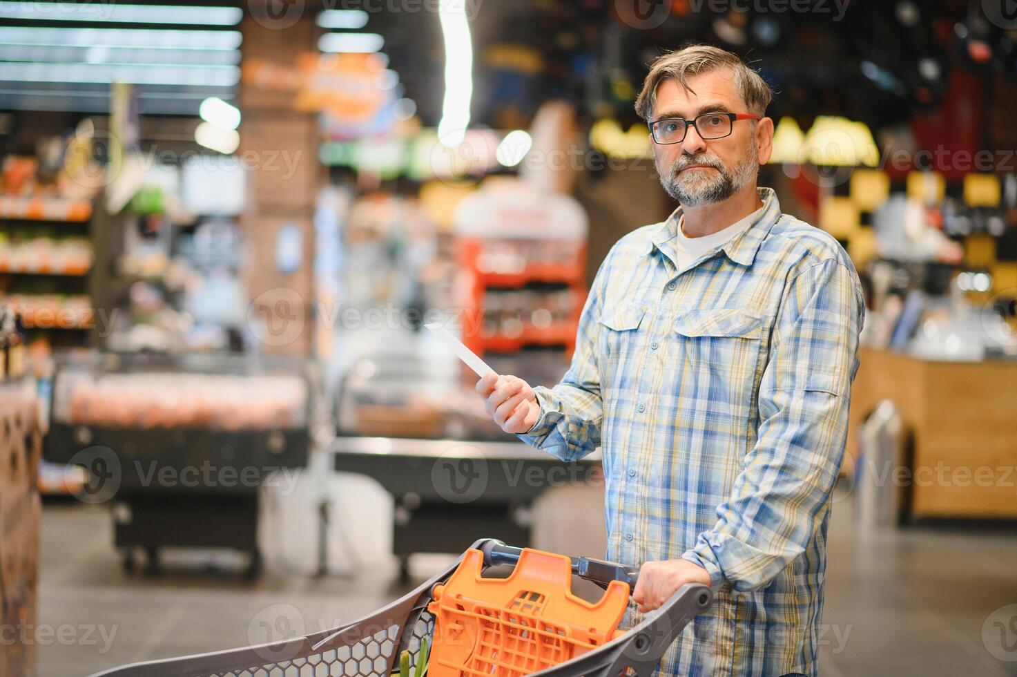 Senior man at grocery store products photo