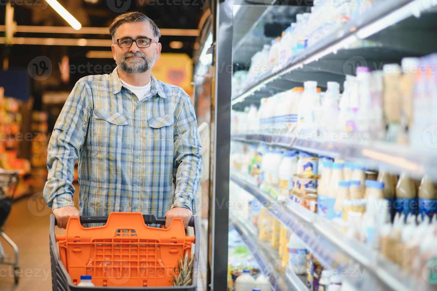 Man holding milk bottle in the supermarket photo