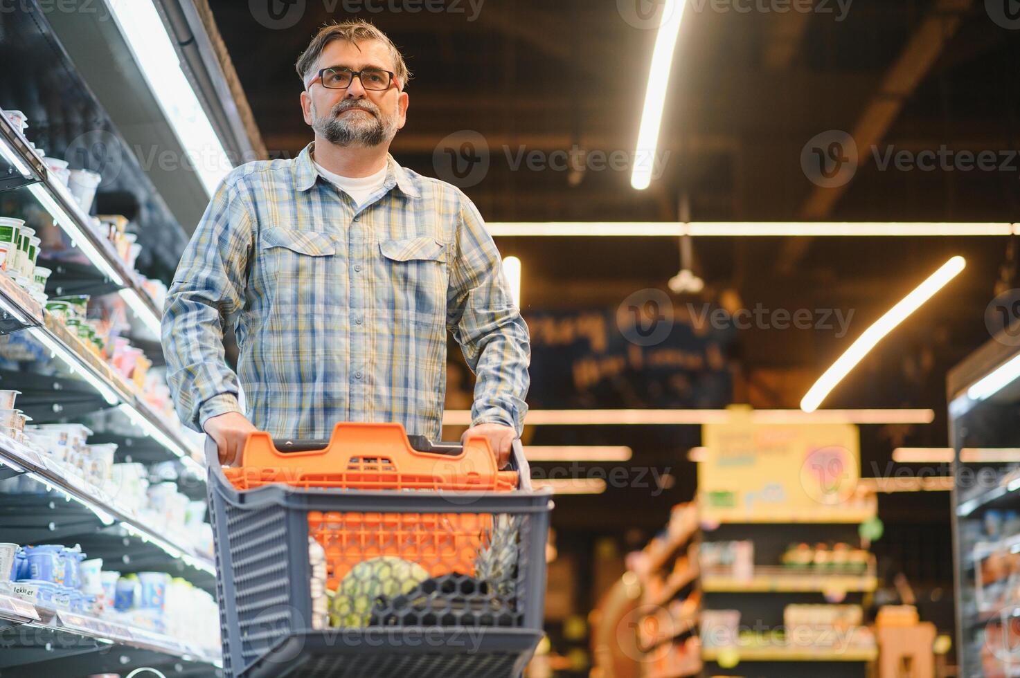 Senior man at supermarket store photo