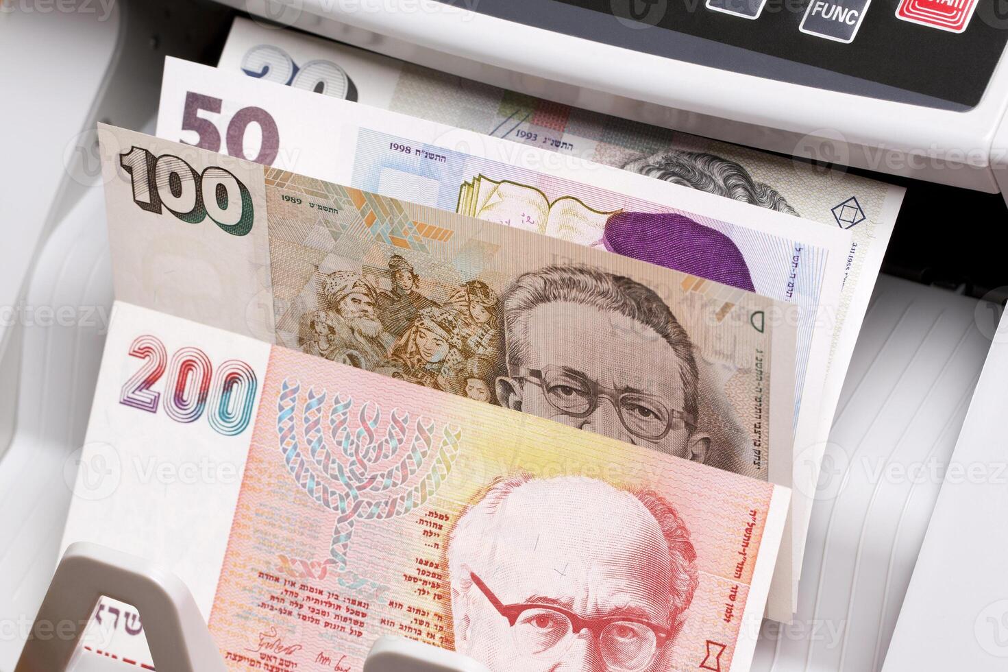 Israeli new shekel in the counting machine photo